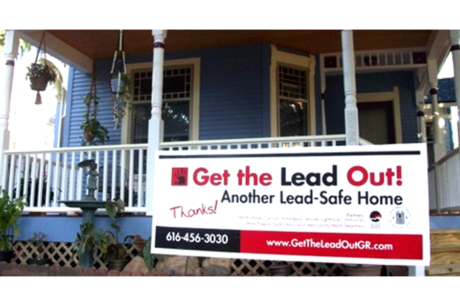Photo of the front porch of a home with a sign reading, 