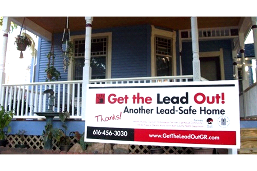 Photo of the front porch of a home with a sign reading,